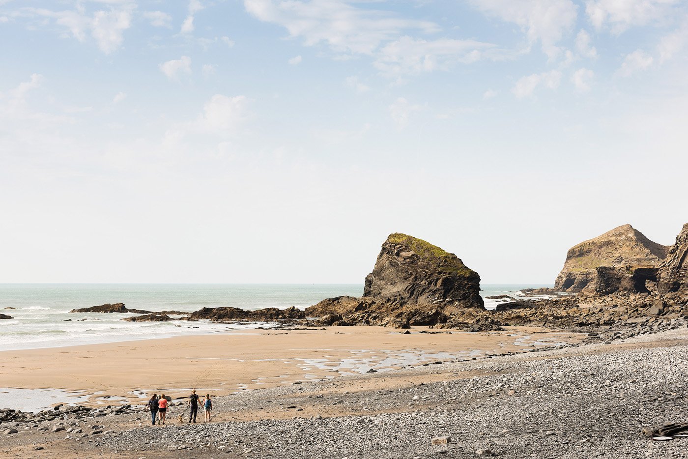 North Cornwall Strangles beach on a clear day with family in the foreground